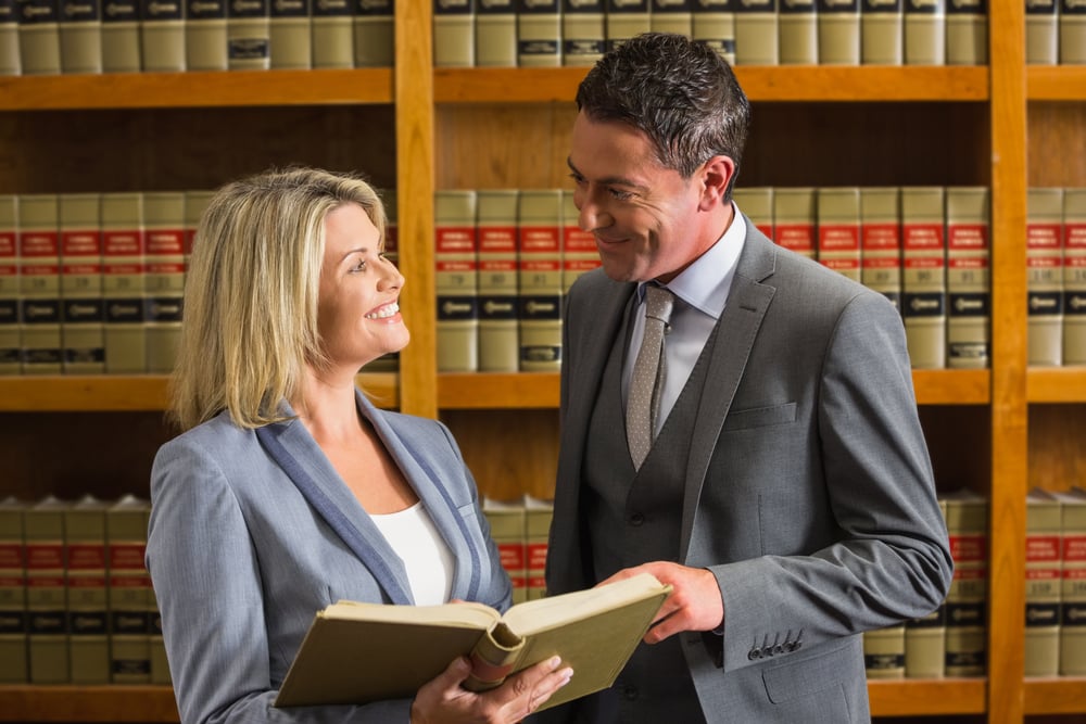 Lawyers reading book in the law library at the university Lawyers reading book in the law library at the university